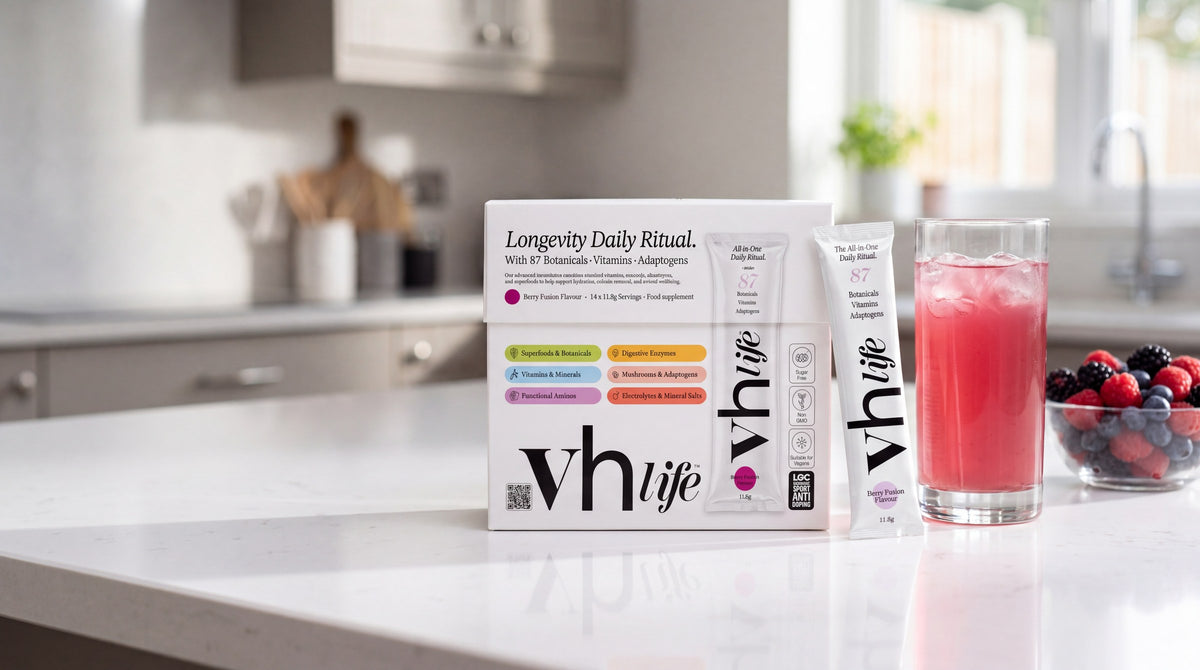 The VH Life box, a sachet and a glass of the berry drink on a kitchen counter