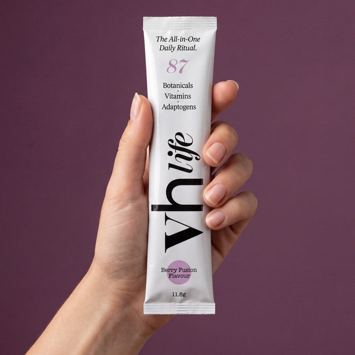 A hand holding a VH Life sachet
