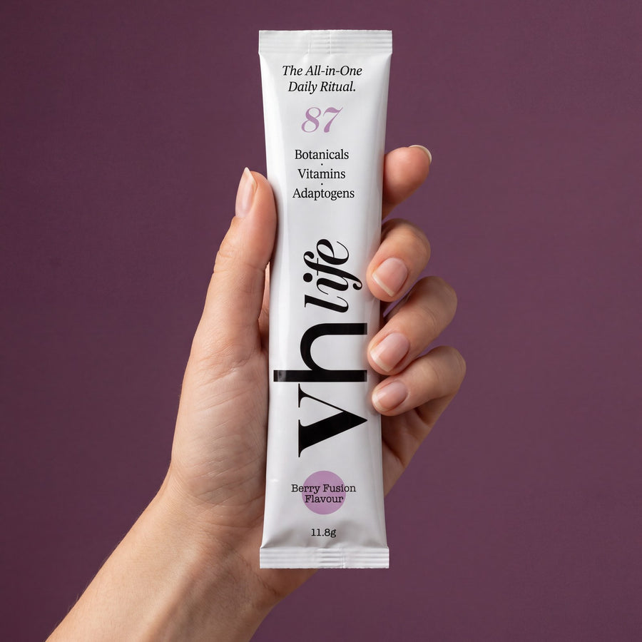 A hand holding a VH Life Berry Fusion sachet
