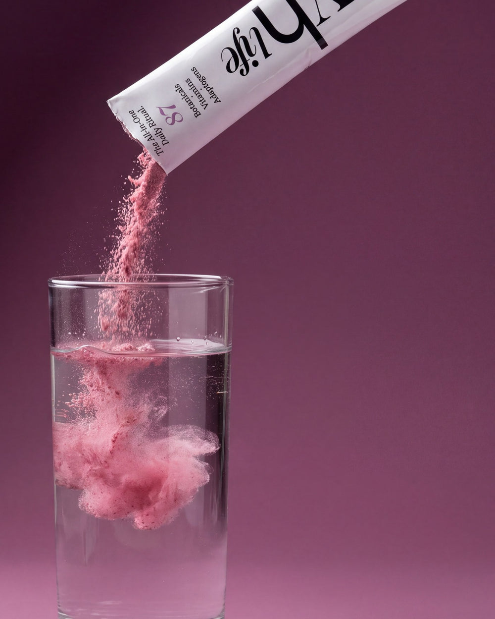 A sachet of VH Life pouring into a glass of water