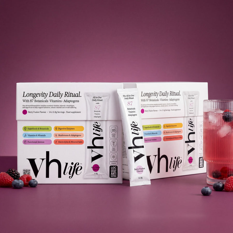 Two VH Life boxes with a sachet and a glass of the berry drink