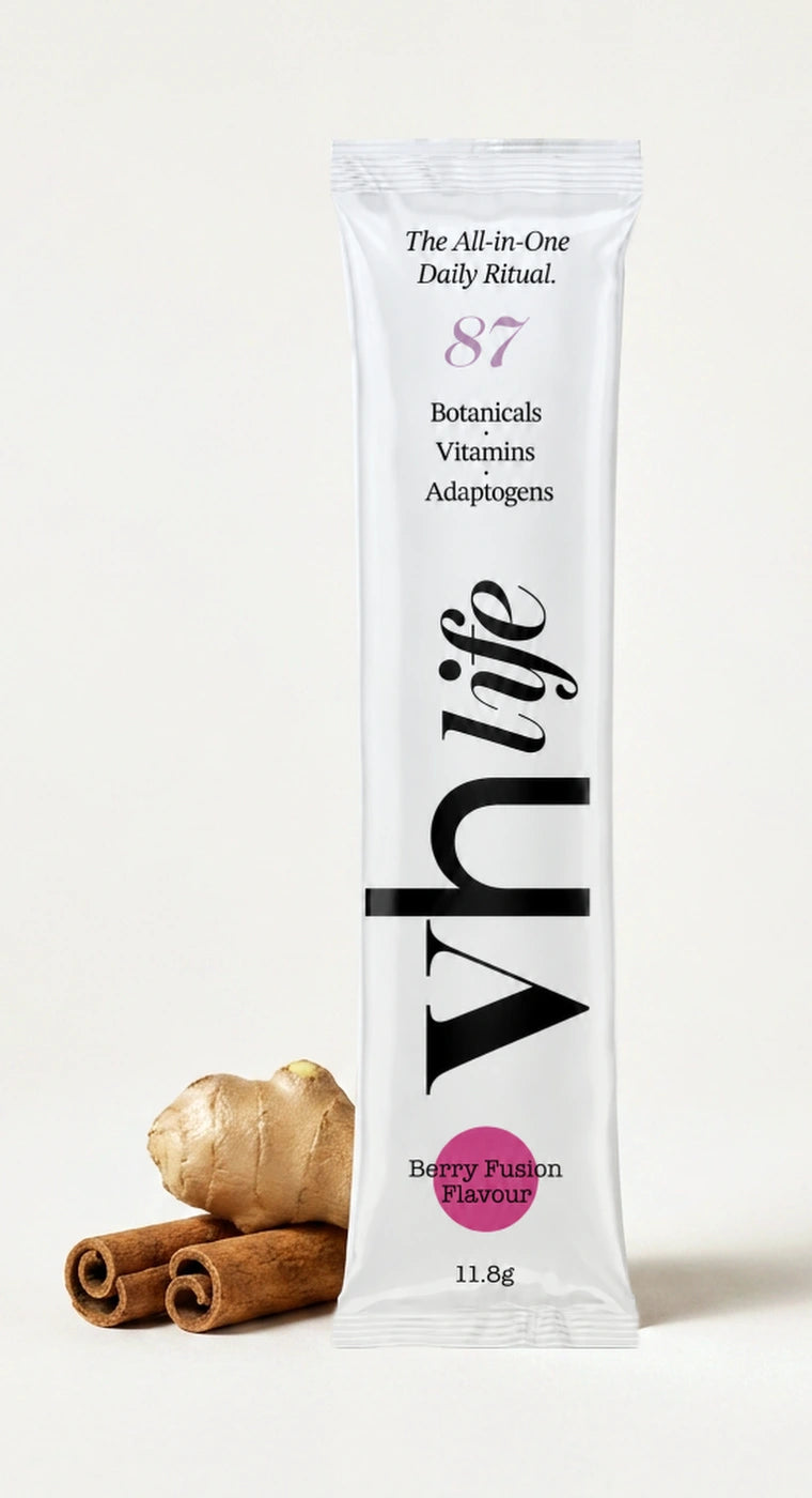 A VH Life Berry Fusion sachet photographed beside fresh ginger root and cinnamon bark