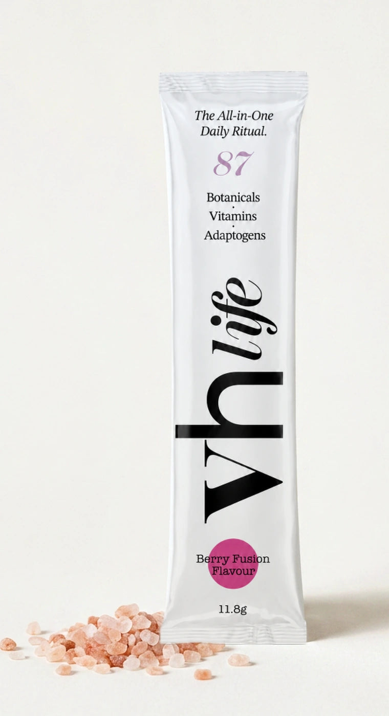 A VH Life Berry Fusion sachet photographed beside coarse pink Himalayan rock salt