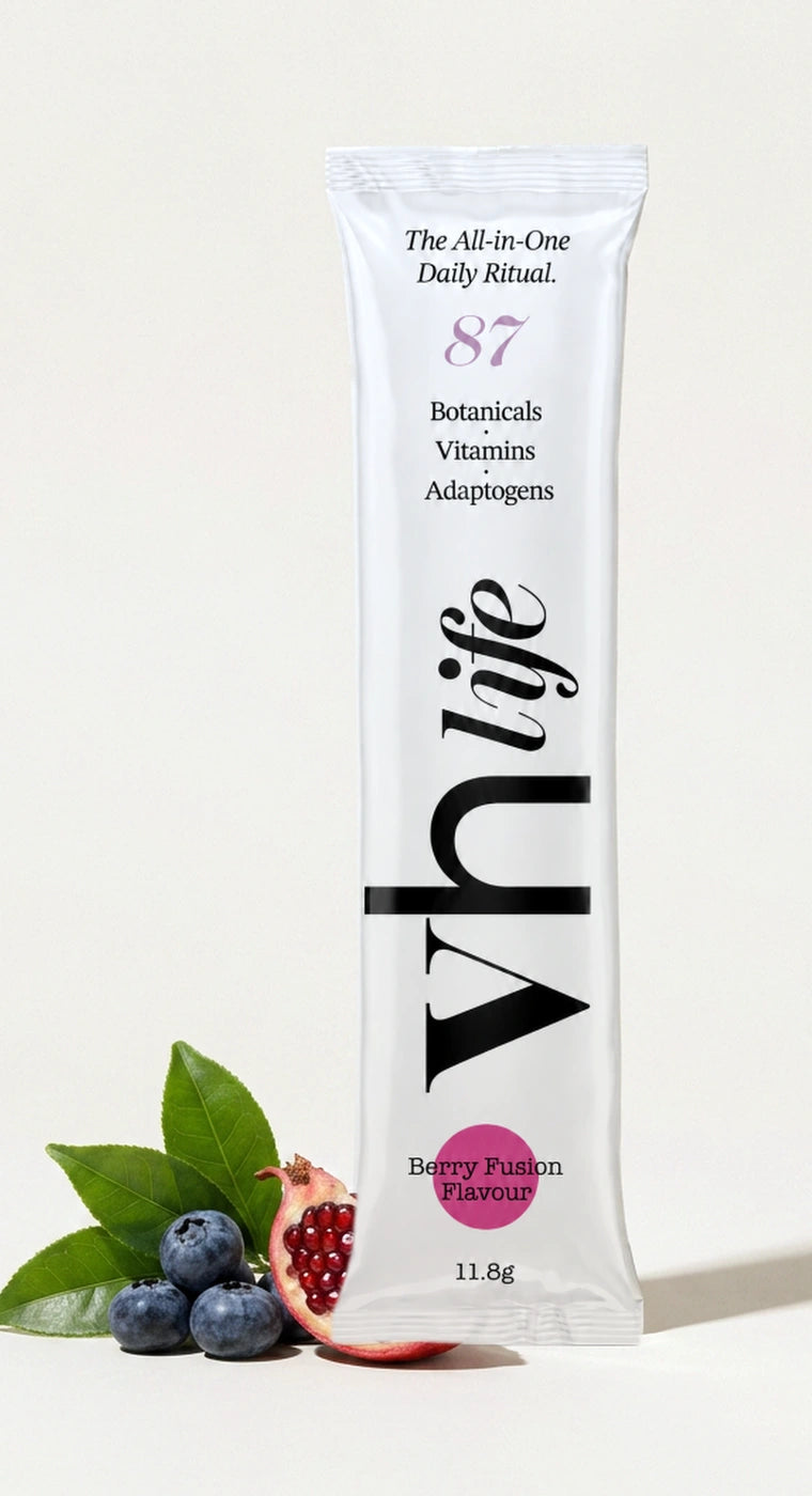 A VH Life Berry Fusion sachet photographed beside blueberries, green tea leaves and pomegranate